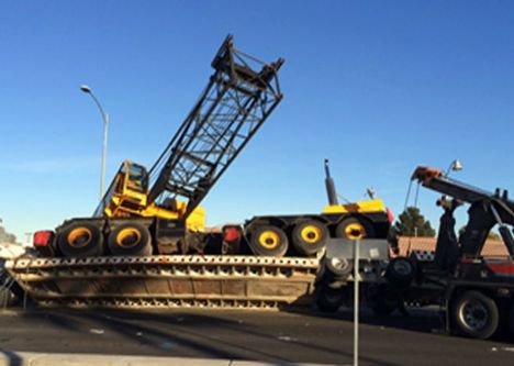 Low loader partially overturned